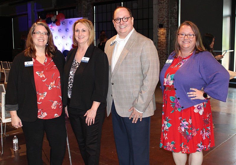 Carrie Miller, SPSFNWA chief program officer (from left); Shannon Campbell, chief operating officer; Tyler B. Clark, chief executive officer; and Frankie Rankin, chief philanthropy officer, welcome guests to the merger celebration July 7 at Record in Bentonville. 
(NWA Democrat-Gazette/Carin Schoppmeyer)