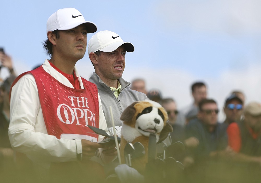 Northern Ireland's Rory McIlroy waits to tee off with his caddie on the 3rd tee during the second round of the British Open Golf Championship at Royal St George's golf course Sandwich, England, Friday, July 16, 2021. (AP Photo/Ian Walton)