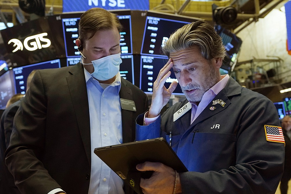 Floor Official Brendan Connolly, left, and trader John Romolo confer on the floor of the New York Stock Exchange, Friday, July 16, 2021. Stocks are off to a slightly higher start on Wall Street Friday with an assist from several big technology companies. (AP Photo/Richard Drew)