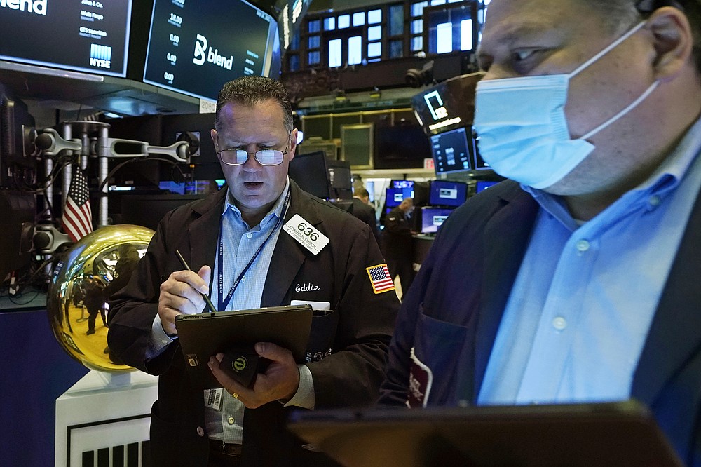 Trader Edward Curran, left, works on the floor of the New York Stock Exchange, Friday, July 16, 2021. Stocks are off to a slightly higher start on Wall Street Friday with an assist from several big technology companies. (AP Photo/Richard Drew)