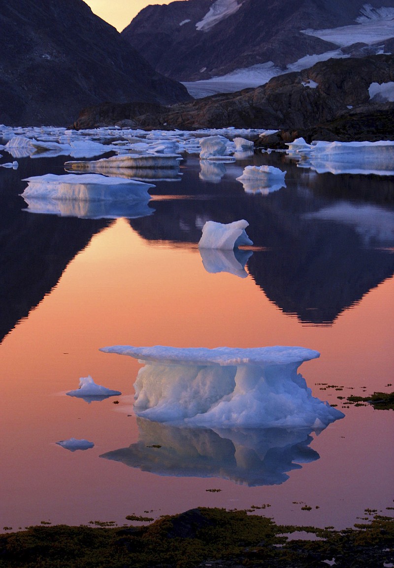 FILE - This is a Tuesday Aug 16, 2005 file image of an iceberg as it floats in the bay in Kulusuk, Greenland near the arctic circle. The left-leaning  government on Greenland which could be sitting on vast amounts of oil, has decided to suspend all oil exploration, Friday July 16, 2021, calling it “a natural step” because the Arctic government “takes the climate crisis seriously.” (AP Photo/John McConnico, FILE)