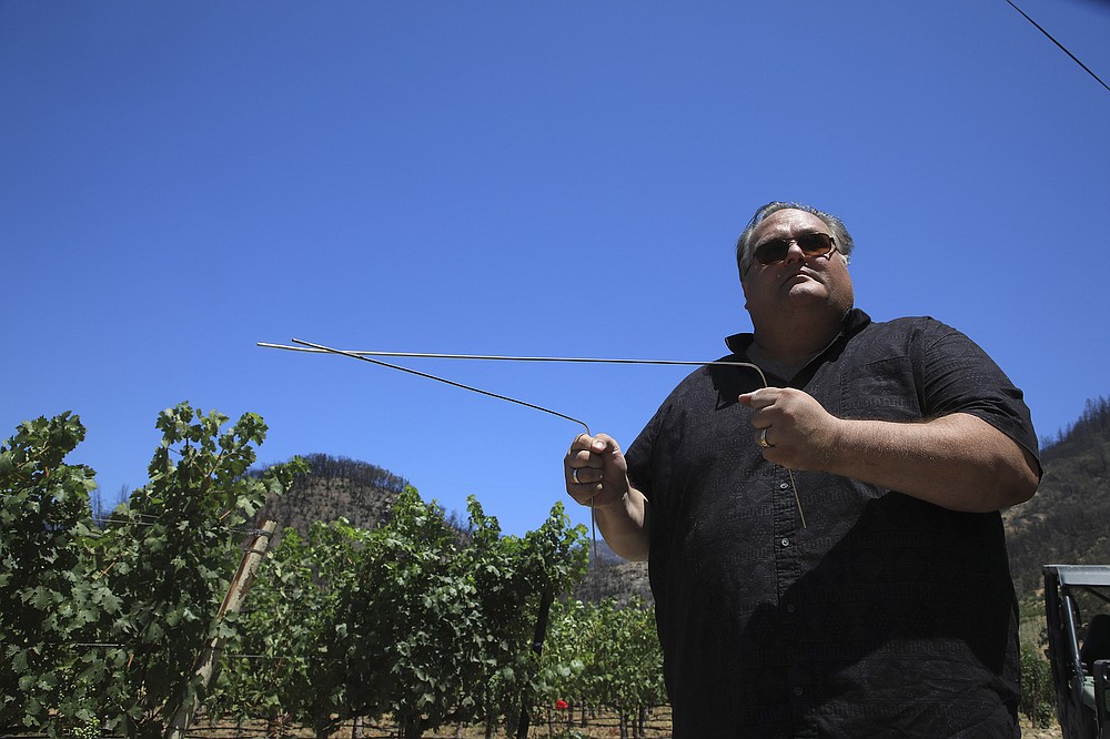 **EMBARGO: No electronic distribution, Web posting or street sales before 3:01 a.m. ET Saturday, July 17, 2021. No exceptions for any reasons. EMBARGO set by source.** Rob Thompson with the stainless steel “L” rods he uses while dowsing for water at a Napa Valley vineyard in Calistoga, Calif., July 13, 2021. Amid California’s drought, desperate landowners and managers are turning to those who practice an ancient, disputed method for locating water. (Jim Wilson/The New York Times)