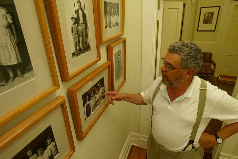 FILE — Peter Miller tells the story Tuesday of the subjects of one of the Mike Disfarmer prints hanging in his Little Rock office in this Aug. 23, 2005 file photo. (Arkansas Democrat-Gazette/STATON BREIDENTHAL)