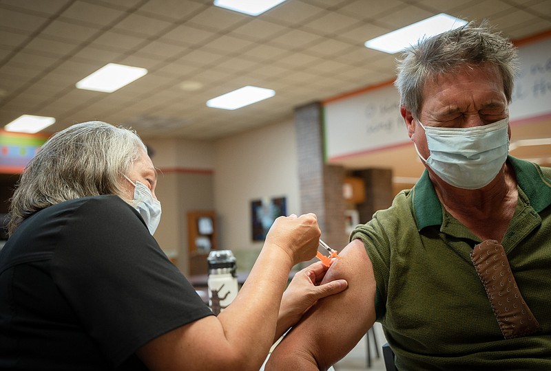 Nurse Susan Hinck gives Richard Thornton a coronavirus vaccine July 10 in Springfield, Mo., where hospital wards have filled with covid-19 patients. MUST CREDIT: photo for The Washington Post by Christopher Smith.