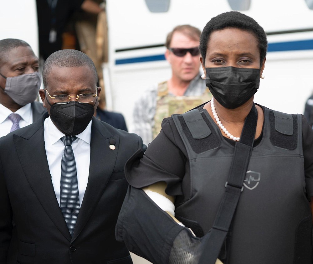 In this handout photo released by Haiti's Secretary of State for Communication, Haiti's first lady Martine Moise, wearing a bullet proof vest and her right arm in a sling, arrives at the Toussaint Louverture International Airport, in Port-au-Prince, Haiti, Saturday, July 17, 2021. Martine Moise, the wife of assassinated President Jovenel Moise, who was injured in the July 7 attack at their private home, returned to the Caribbean nation on Saturday following her release from a Miami hospital. (Haiti's Secretary of State for Communication Photo/via AP)
