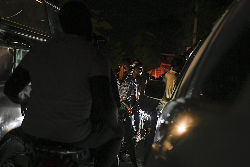 Motorcyclists waits in a long line to fill up their tanks at a gas station amid a fuel shortage in Port-au-Prince, Haiti, late Saturday, July 17, 2021. The country of more than 11 million people are still reeling from the July 7 killing of President Jovenel Moïse. (AP Photo/Matias Delacroix)
