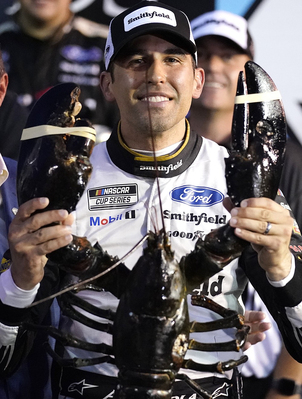 Aric Almirola smiles as he holds up a giant lobster after winning the NASCAR Cup Series auto race Sunday, July 18, 2021, in Loudon, N.H. (AP Photo/Charles Krupa)