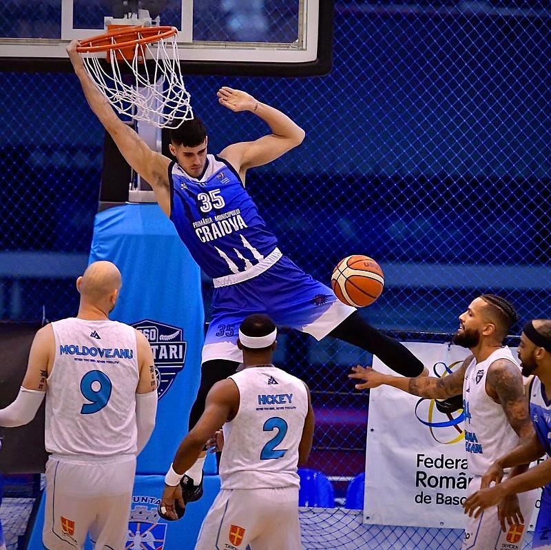 Photo submitted
Former Siloam Springs star Payton Henson dunks a basketball while playing for SCM CSU Craiova in Romania. Henson recently signed with Belfius Mons-Hainaut in Belgium for the 2021-22 season.
