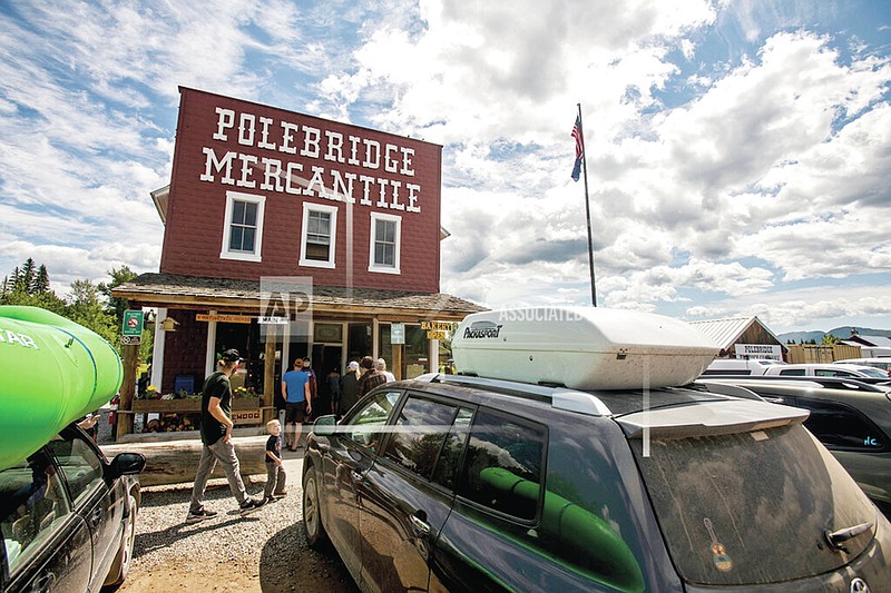 FILE - This July 5, 2020 file photo shows The Polebridge Mercantile, one of two establishments at the outpost in Polebridge, Mont. The entrance accesses a less developed part of Glacier National Park. Traffic in the area has quadrupled in the past decade and the new reservation system limiting vehicle access to the Going-to-the-Sun Road has led even more people to look for other ways into the park. North Fork District Ranger Jim Dahlstrom says for a lot of people, Polebridge is their Plan B, and the off-the-grid area wasn't intended for the spontaneous visitor. (Ben Allan Smith/The Missoulian via AP)