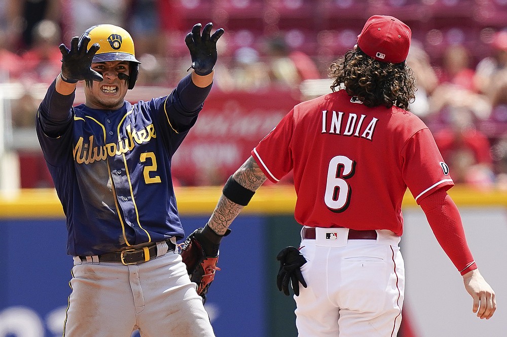 Milwaukee Brewers' Luis Urias (2) celebrates a play during the fifth inning of a baseball game against the Cincinnati Reds in Cincinnati, Sunday, July 18, 2021. (AP Photo/Bryan Woolston)