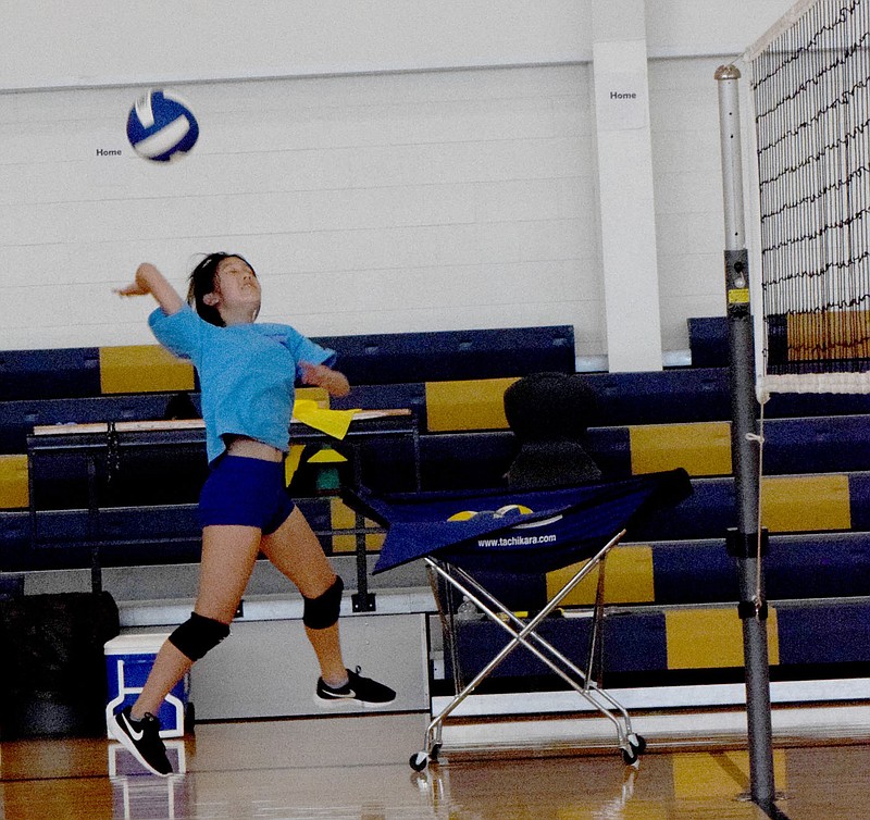 Westside Eagle Observer/MIKE ECKELS
McKenzie Thao fires the ball over the net during the Thursday morning junior high Lady Bulldog volleyball practice in Decatur.