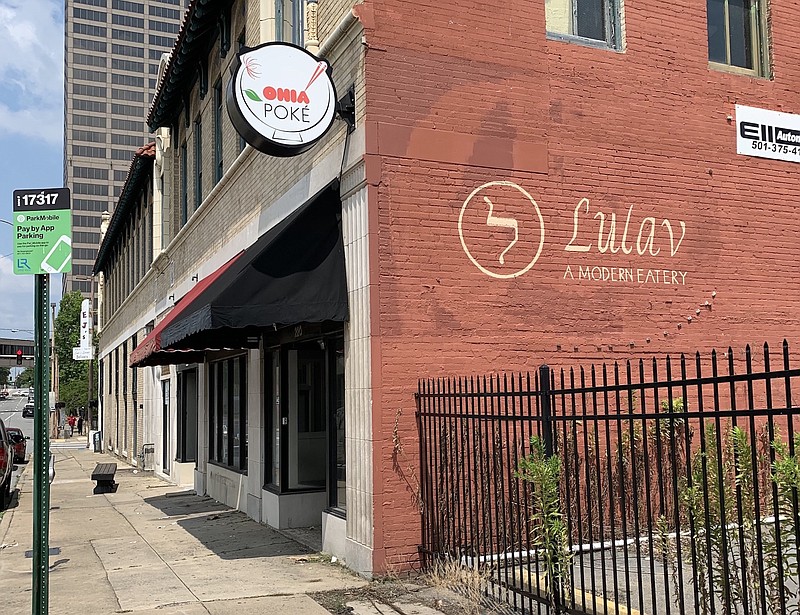 The storefront at 220 W. Sixth St., Little Rock, where Fat Jaws Soul Food and Southern Eats is headed, still shows a sign for Ohia Poke and a much older logo on the side for Lulav, the first restauraant to occupy the space. (Arkansas Democrat-Gazette/Eric E. Harrison)