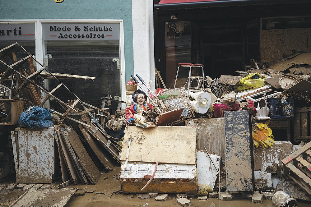 A pile of rubbish is seen in the town Bad Neuenahr-Ahrweiler, Germany, Monday July 19, 2021. More than 180 people died when heavy rainfall turned tiny streams into raging torrents across parts of western Germany and Belgium, and officials put the death toll in Ahrweiler county alone at 110. (AP Photo/Bram Janssen)
