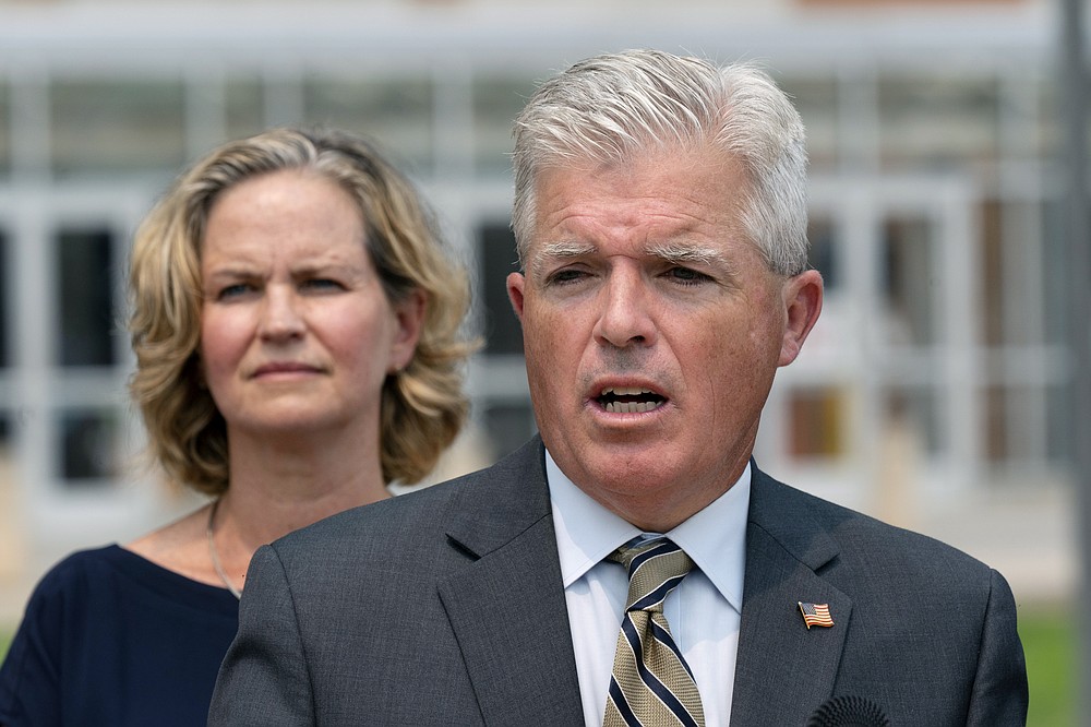 Suffolk County Executive Steve Bellone, right, speaks at a news conference to discuss a settlement in an opioid trial, Tuesday, July 20, 2021, in Central Islip, N.Y. Nassau County Executive Laura Curran is behind him. New York State reached an agreement Tuesday with the distribution companies AmerisourceBergen, Cardinal Health and McKesson to settle an ongoing trial. That deal alone would generate more than $1 billion to abate the damage done by opioids there. The trial is expected to continue, but the settlement leaves only three drug manufacturers as defendants. (AP Photo/Mark Lennihan)