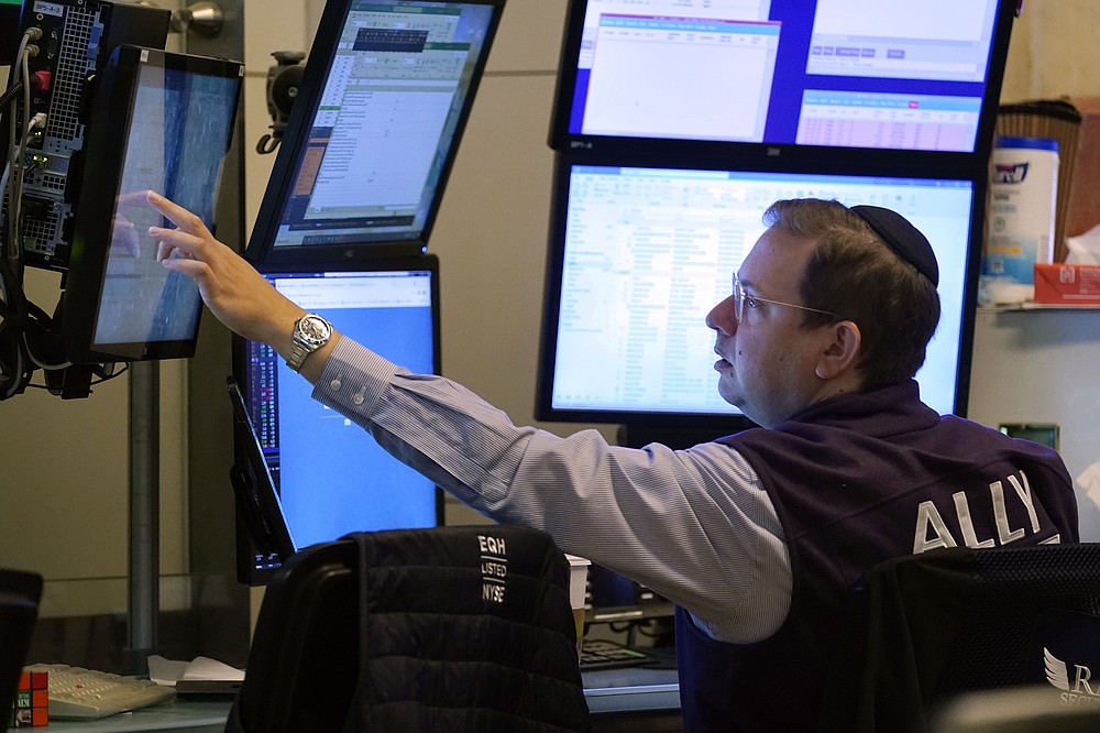 Trader Michael Bercovici works the floor of the New York Stock Exchange, Tuesday, July 20, 2021. Stocks are opening higher on Wall Street Tuesday as investors shake off a rout a day earlier brought on by concerns about the spread of a more contagious variant of COVID-19. (AP Photo/Richard Drew)
