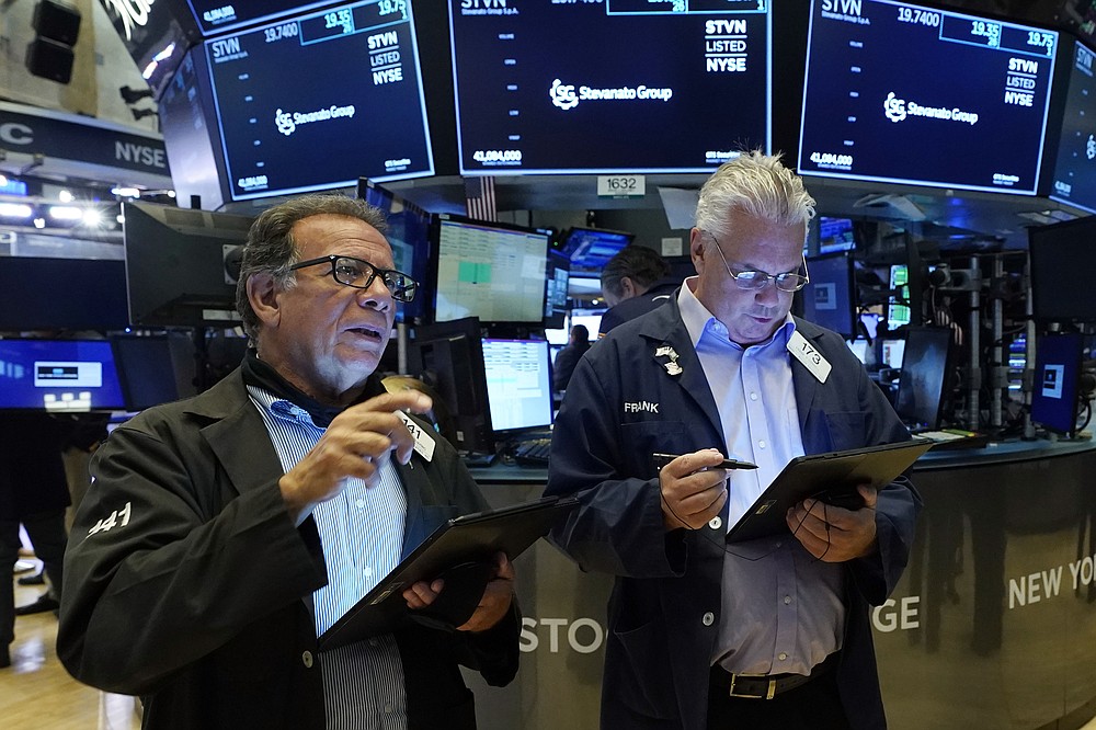 Traders Sal Suarino, left, and Frank O'Connell work on the floor of the New York Stock Exchange, Tuesday, July 20, 2021. Stocks are opening higher on Wall Street Tuesday as investors shake off a rout a day earlier brought on by concerns about the spread of a more contagious variant of COVID-19. (AP Photo/Richard Drew)