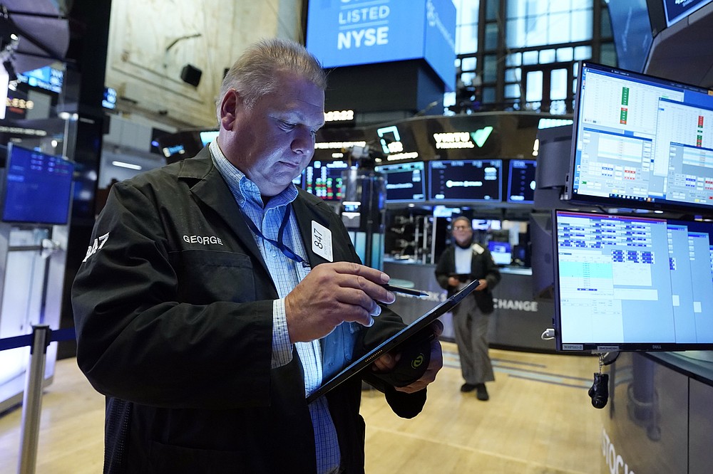 Trader George Ettinger works on the floor of the New York Stock Exchange, Tuesday, July 20, 2021. Stocks are opening higher on Wall Street Tuesday as investors shake off a rout a day earlier brought on by concerns about the spread of a more contagious variant of COVID-19. (AP Photo/Richard Drew)