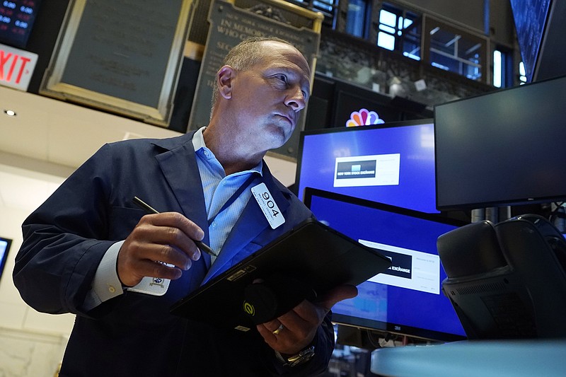 Trader Michael Urkonis works on the floor of the New York Stock Exchange, Tuesday, July 20, 2021. Stocks are opening higher on Wall Street Tuesday as investors shake off a rout a day earlier brought on by concerns about the spread of a more contagious variant of COVID-19. (AP Photo/Richard Drew)