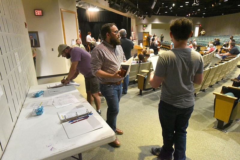 People sign up to speak Tuesday July 20 2021 during the Benton County Quorum Court committee of the whole meeting at Northwest Arkansas Community College.
(NWA Democrat-Gazette/Flip Putthoff)