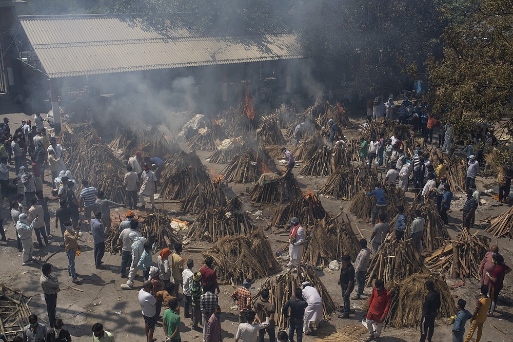 FILE - In this April 24, 2021, file photo, multiple funeral pyres of those who died of COVID-19 burn at a ground that has been converted into a crematorium for the mass cremation of coronavirus victims, in New Delhi, India. India's excess deaths during the pandemic could be a staggering 10 times the official COVID-19 toll, likely making it modern India's worst human tragedy, according to the most comprehensive research yet on the ravages of the virus in the south Asian country. (AP Photo/Altaf Qadri, File)