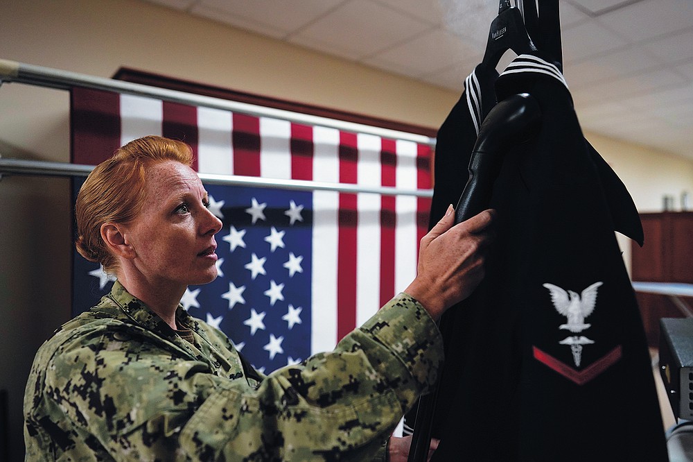 Chief Hospital Corpsman, United States Fleet Marine Forces, Jessica Zugzda  steams a dress Navy uniform in the uniform shop of the Air Force Mortuary  Affairs Operations center at Dover Air Force Base