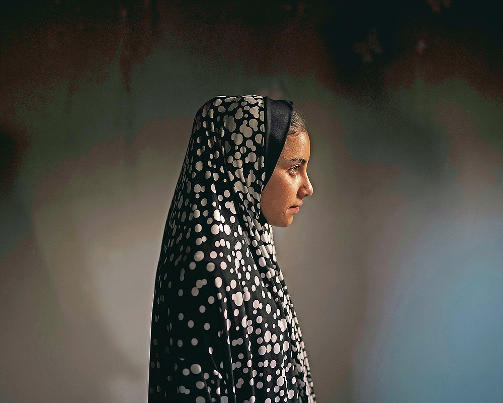 Batool al-Masri, 14, poses for a portrait at her house in Beit Hanoun, northern Gaza Strip, Sunday, June 20, 2021. In a field near their home on May 10, Batool carried her cousin Yazan, a toddler barely 2 years old. "Twenty-four hours a day she was spoiling him," says Batool's father, Mohammed Atallah al-Masri. Then, an explosion. It's not clear whether the rocket was fired by Israel or Hamas. But in an instant, eight people were dead, including six children. Yazan bled out in front of Batool. She tried to save him, ignoring injuries to her legs and pelvis. (AP Photo/Felipe Dana)