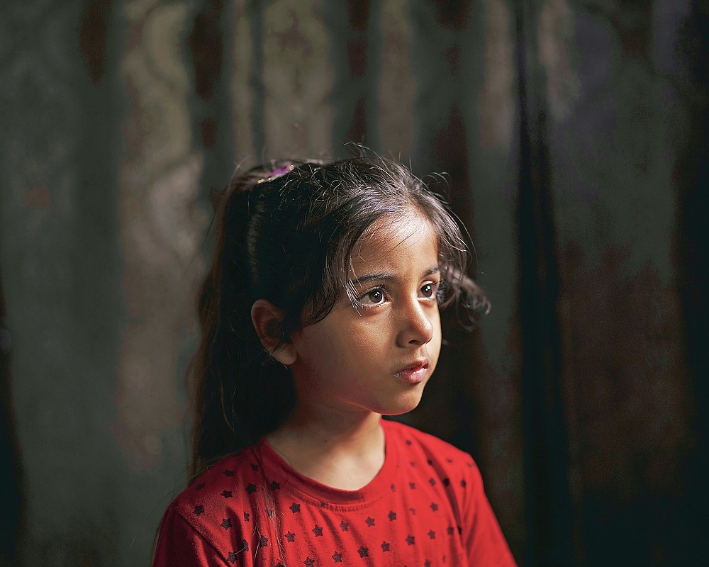 Elien al-Madhoun, 6, poses for a portrait at her grandfather's house, where she is living after her house was destroyed during an 11-day war, in Beit Lahia, northern Gaza Strip, Saturday, June 19, 2021. Elien was not yet born when her father lost his home in the 2014 Gaza War. Young as she is, she doesn't entirely understand life and death. But in May, she screamed out at the sounds of airstrikes and shelling in Bait Lahia in northern Gaza, says her father, Ahmed Rabah al-Madhoun. “When nine homes are completely destroyed next to one another and my daughter sees this, she can’t understand what happened,” he says. (AP Photo/Felipe Dana)
