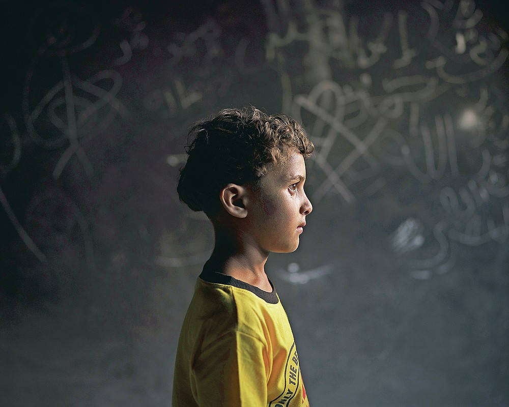 Qasim al-Masri, 6, poses for a portrait at his house in Beit Hanoun, northern Gaza Strip, on Sunday, June 20, 2021. A May 10 explosion in a field near their home killed his best friend and cousin, Marwan, 7. They'd been inseparable, even in school, his father says. Marwan's only brother, Ibrahim, 11, also was killed. The attack "completely changed" Qasim, his father says. The young boy talks to himself. At night, he's paralyzed by fear and does not get out of bed to use the bathroom. (AP Photo/Felipe Dana)
