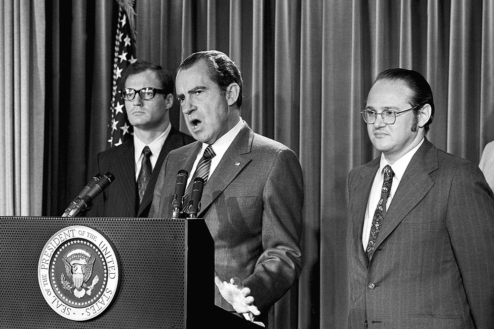 FILE - In this June 17, 1971, file photo, President Richard Nixon explains aspects of the special message sent to the Congress, asking for an extra $155 million for a new program to combat the use of drugs. He labeled drug abuse "a national emergency" and said the money would be used to "tighten the noose around the necks of drug peddlers and thereby loosen the noose around the necks of drug users." At left is Egil Krogh, deputy director of the Domestic Council. At right is Dr. Jerome Jaffe, who was recruited by Nixon to lead a new drug strategy. (AP Photo/Harvey Georges, File)