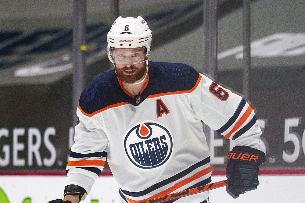 FILE - Edmonton Oilers' Adam Larsson (6) is shown during an NHL hockey game against the Vancouver Canucks in Vancouver, British Columbia, in this Monday, May 3, 2021, file photo. Adam Larsson and Chris Driedger are going to the Seattle Kraken in the expansion draft. One person with knowledge of Larsson's deal said the defenseman has agreed to terms with Seattle on a $16 million, four-year contract. Another person with knowledge of Driedger's deal said the goaltender has agreed to a $10.5 million, three-year contract. The people spoke to The Associated Press on condition of anonymity Wednesday morning because the team was not announcing any moves until the expansion draft Wednesday night, July 21, 2021. (AP Photo/Nick Didlick, File)
