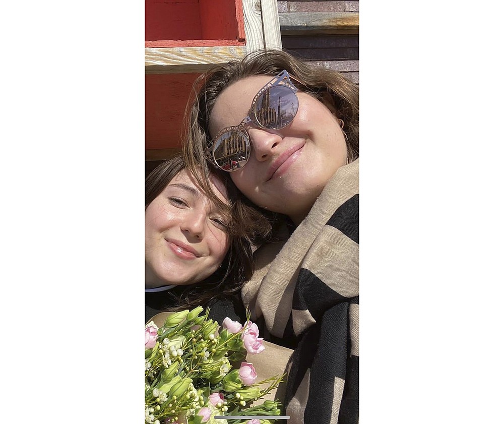 In this undated photo provided by Sergiy Gromov, Anastasia Gromova, right, is shown with her best friend Michelle Pazos. Pazos body was found. Nearly a month later, Anastasia is among the last of those missing in the Champlain Towers South collapse, the 24-year-old had just been accepted to a program teaching English to students in Japan. The young go-getter was visiting friends at the Surfside condo for one last hurrah. (Sergiy Gromov via AP)