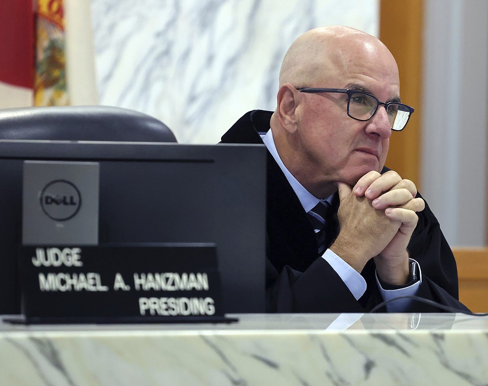 Miami-Dade Circuit Judge Michael Hanzman listens as tenants share their thoughts regarding the future of the site of the Champlain Towers South building that collapsed in Surfside, Fla., during a hearing, Wednesday, July 21, 2021, in Miami. Hanzman said victims and families who suffered losses in the collapse of the 12-story oceanfront Florida condominium will get a minimum of $150 million in compensation initially. (Carl Juste/Miami Herald via AP, Pool)