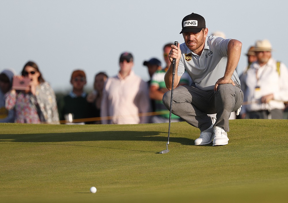 South Africa's Louis Oosthuizen looks at the line of his putt on the 17th green during the third round of the British Open Golf Championship at Royal St George's golf course Sandwich, England, Saturday, July 17, 2021. (AP Photo/Peter Morrison)