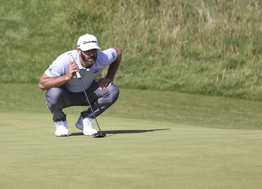 United States' Dustin Johnson lines up his putt on the 6th green during the third round of the British Open Golf Championship at Royal St George's golf course Sandwich, England, Saturday, July 17, 2021. (AP Photo/Ian Walton)