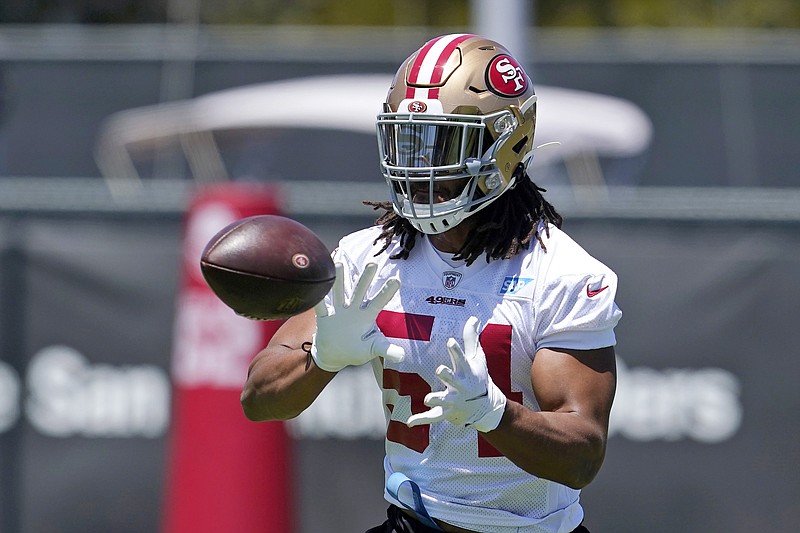 FILE - In this May 25, 2021, file photo, San Francisco 49ers linebacker Fred Warner reaches for ball during NFL football practice in Santa Clara, Calif. The 49ers agreed on a five-year contract extension with Warner that makes him the highest-paid off-ball linebacker in the NFL. A person familiar with the deal said on condition of anonymity that the extension that runs through 2026 is worth about $95 million with $40.5 million in guarantees. The person spoke on condition of anonymity because the team hadn't announced the deal yet.   (AP Photo/Jeff Chiu, FIle)