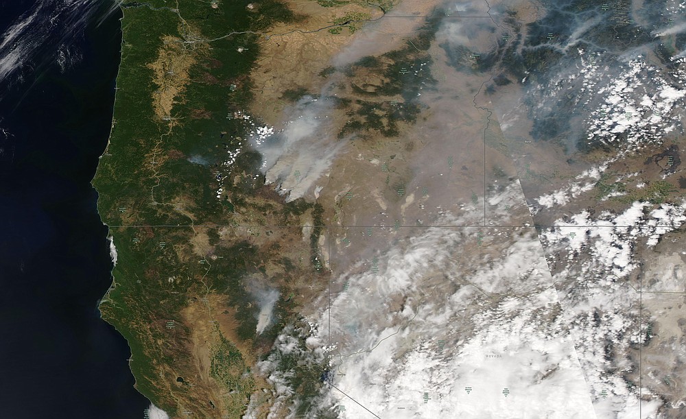 This satellite image provided by Satellite image ©2021 Maxar Technologies shows overview of wildfires from Oregon, Idaho, and Northern California on Sunday, July 18, 2021. Extremely dry conditions and heat waves tied to climate change have made wildfires harder to fight. Climate change has made the West much warmer and drier in the past 30 years and will continue to make weather more extreme and wildfires more frequent and destructive. (Satellite image ©2021 Maxar Technologies via AP)