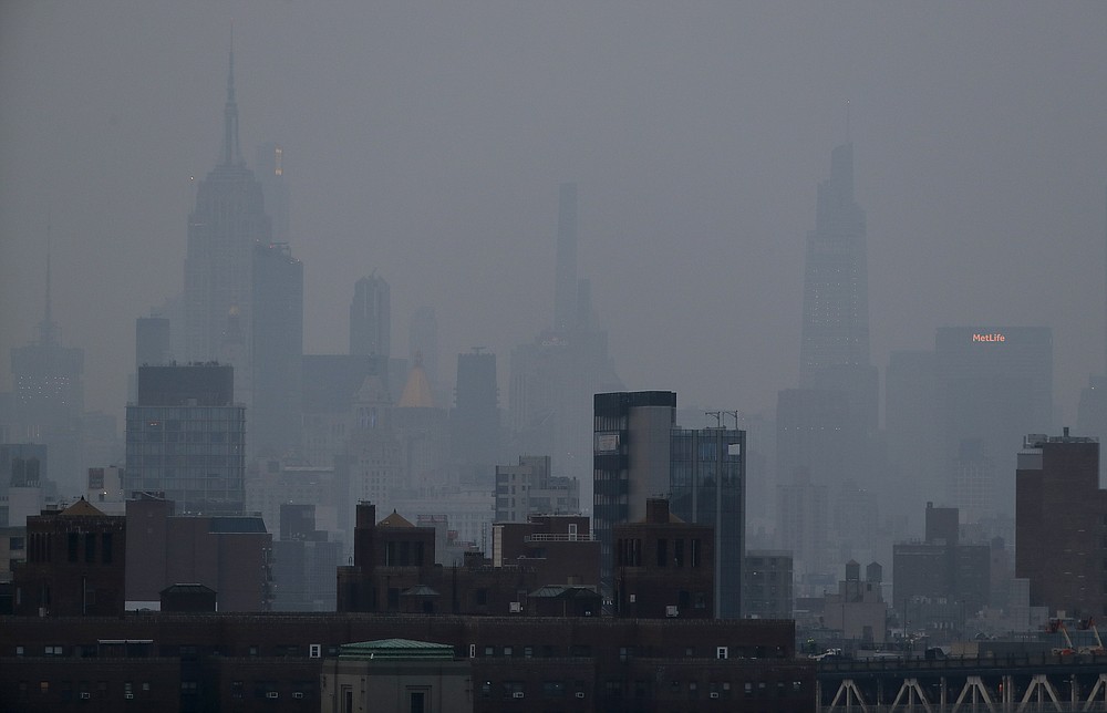 A thick haze hangs over Manhattan, Tuesday, July 20, 2021, in New York. Wildfires in the American West, including one burning in Oregon that's currently the largest in the U.S., are creating hazy skies as far away as New York as the massive infernos spew smoke and ash into the air in columns up to six miles high. (AP Photo/Julie Jacobson)