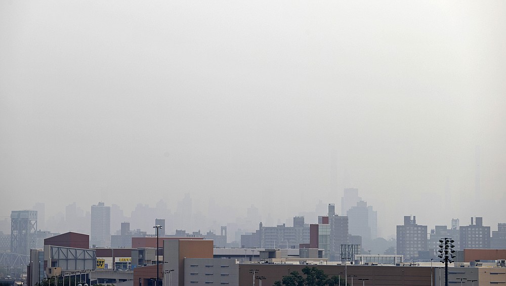 Smoke blocks the view looking toward Manhattan from Yankee Stadium before the Philadelphia Phillies played the New York Yankees in a baseball game Tuesday, July 20, 2021, in New York. (AP Photo/Adam Hunger)