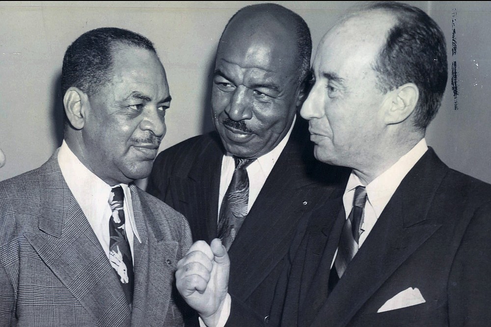 From left, Rep. William Dawson, Cook County Municipal Court judge candidate Frederick "Duke" Slater and Adlai Stevenson, candidate for governor, are shown in this Oct. 31, 1948, photo. Slater was the NFL’s first African-American lineman, and often the only Black player on the field. After retiring, he broke down more racial barriers to become a judge in Chicago. (Chicago Sun-Times via AP)