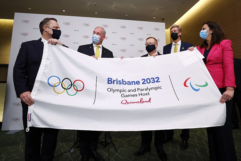 The Right Honourable the Lord Mayor of Brisbane, Councillor Adrian Schrinner, Senator the Honourable Richard Colbeck, Minister for Senior Australians and Aged Care Services and Minister for Sport, John Coates AC, President, Australian Olympic Committee, three time Olympic gold medalist James Tomkins and The Honourable Annastacia Palaszczuk MP, Premier of Queensland and Minister for Trade, attend a press conference after Brisbane was announced as the 2032 Summer Olympics host city during the IOC Session at Hotel Okura in Tokyo, Wednesday, July 21, 2021. (Toru Hanai/Pool Photo via AP)