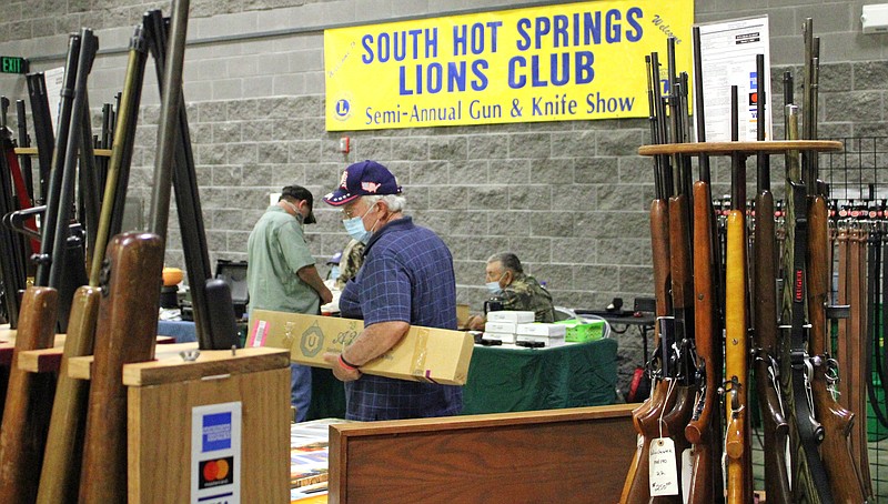 Shoppers look over the booths at the South Hot Springs Lions Club's gun and knife show in July 2020 at the Hot Springs Convention Center. - File photo by The Sentinel-Record