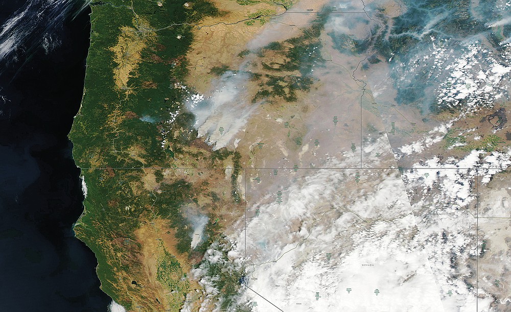 This satellite image provided by Satellite image ©2021 Maxar Technologies shows overview of wildfires from Oregon, Idaho, and Northern California on Sunday, July 18, 2021. Extremely dry conditions and heat waves tied to climate change have made wildfires harder to fight. Climate change has made the West much warmer and drier in the past 30 years and will continue to make weather more extreme and wildfires more frequent and destructive. (Satellite image ©2021 Maxar Technologies via AP)