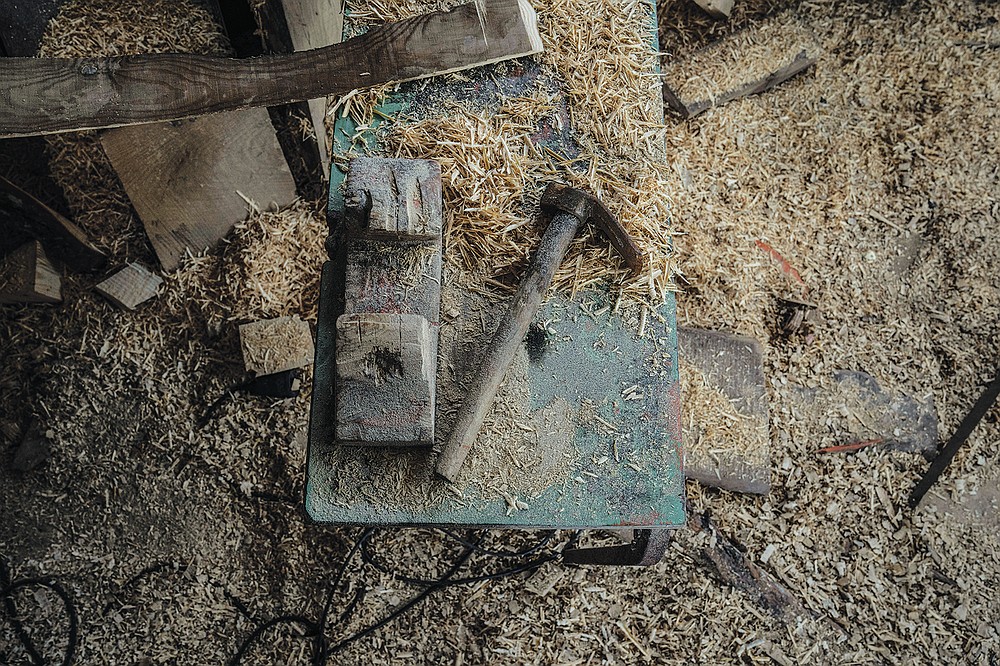 Tools are seen among wood shavings inside a boatyard in Karlovasi town, Samos Island , Greece, Thursday, June 10, 2021. Yes it's an art too, but it's also heavy work, it's tough work," Giorgos Kiassos, one of the last remaining boatbuilders on Samos island said. The art of designing and building these vessels, done entirely by hand, is under threat. Fewer people order wooden boats since plastic and fiberglass ones are cheaper to maintain .(AP Photo/Petros Giannakouris)
