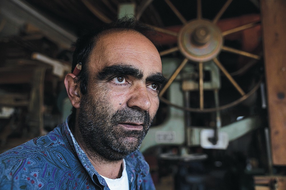 Giorgos Kiassos, one of the last remaining boatbuilders on Samos island, looks on, at his mountain boatyard in the village of Drakaioi , Greece, on Thursday, June 10, 2021. The art of designing and building these vessels, which is done entirely by hand, is under threat. Fewer wooden boats are being ordered, with plastic and fiberglass ones cheaper to maintain .(AP Photo/Petros Giannakouris)