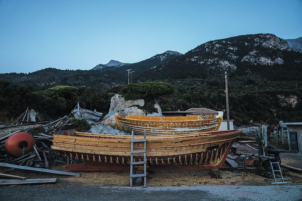 Wooden boats stands at Agios Isidoros boatyard on the eastern Aegean island of Samos, Greece, on Wednesday, June 9, 2021. The art of designing and building these vessels, done entirely by hand, is under threat. Fewer people order wooden boats since plastic and fiberglass ones are cheaper to maintain. (AP Photo/Petros Giannakouris)