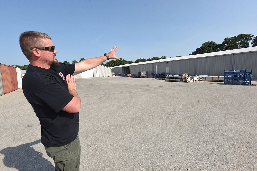 Guy Joubert with Wilson Combat gun makers shows Wednesday July 14 2021 the outside of a major expansion at the company south of Berryville.
(NWA Democrat-Gazette/Flip Putthoff)