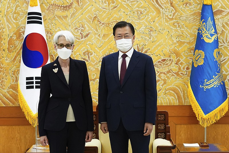 In this photo provided by South Korea Presidential Blue House, South Korean President Moon Jae-in and U.S. Deputy Secretary of State Wendy Sherman, left, pose for photos prior to their meeting at the presidential Blue House in Seoul, South Korea, Thursday, July 22, 2021. Top U.S. and South Korean officials agreed Thursday to try to convince North Korea to return to talks on its nuclear program, which Pyongyang has insisted it won't do in protest of what it calls U.S. hostility. (South Korea Presidential Blue House via AP)