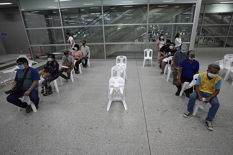 Residents wait for a dose of the AstraZeneca COVID-19 vaccine at the Central Vaccination Center in Bangkok, Thailand, Thursday, July 22, 2021. (AP Photo/Sakchai Lalit)