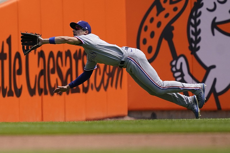Texas Rangers left fielder Eli White dives and catches the fly out hit by Detroit Tigers' Akil Baddoo during the second inning of a baseball game, Thursday, July 22, 2021, in Detroit. (AP Photo/Carlos Osorio)