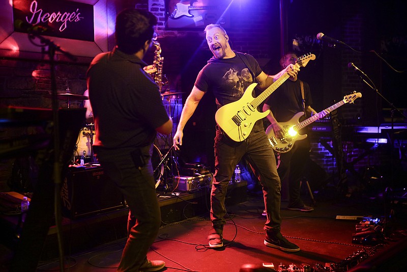 Jim Goza (center) performs with his band The Juice, Saturday, July 17, 2021 at George's Majestic Lounge in Fayetteville. Check out nwaonline.com/210718Daily/ for today's photo gallery. 
(NWA Democrat-Gazette/Charlie Kaijo)